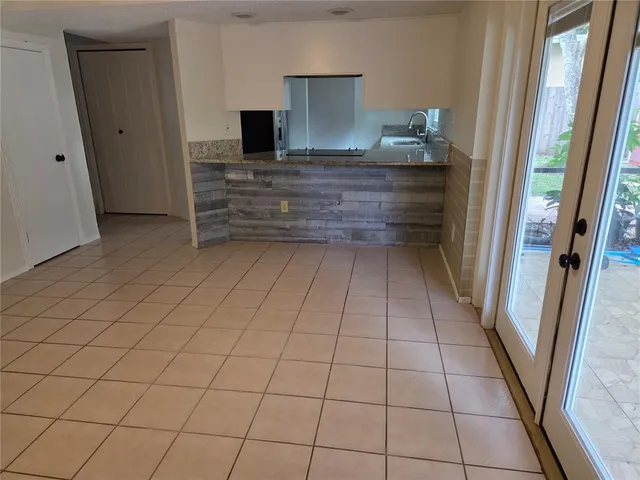 a room with washing machine and storage