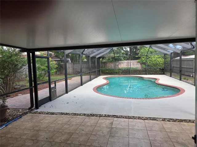 a swimming pool with outdoor seating and yard