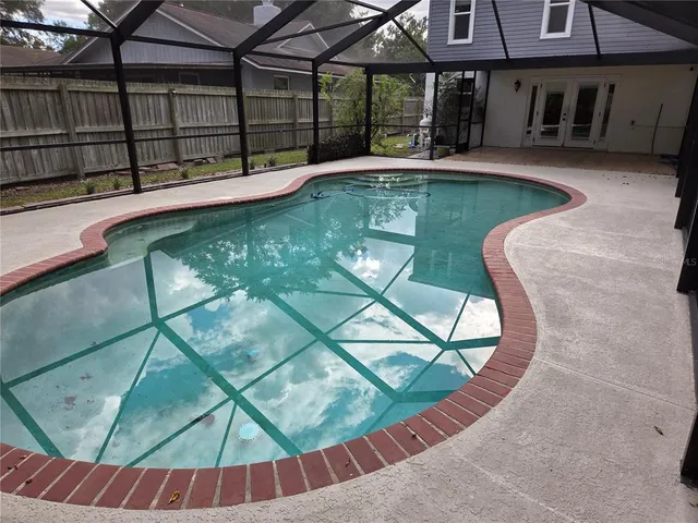 a view of a backyard with plants and a backyard