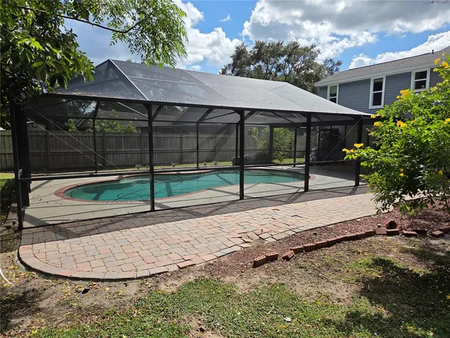 a view of backyard with wooden fence