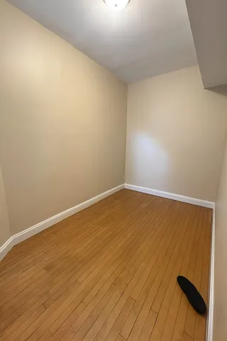 an empty room with wooden floor