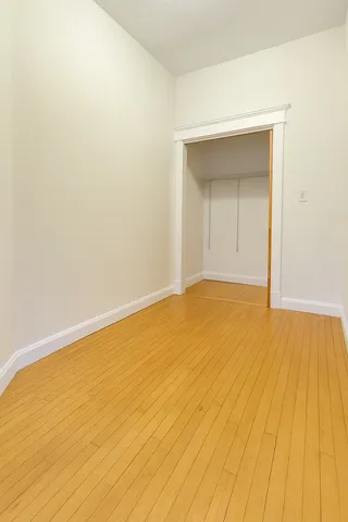 a view of an empty room and wooden floor