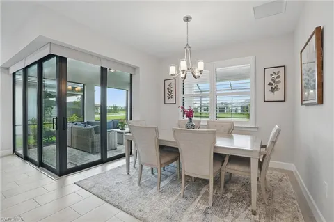 a view of a dining room with furniture wooden floor and chandelier