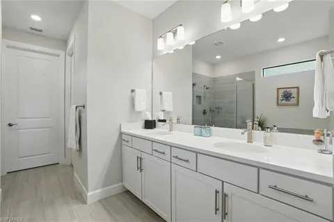 a bathroom with a double vanity sink and mirror