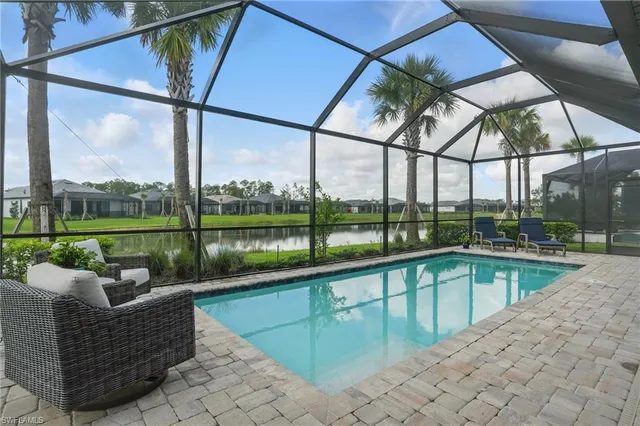 a view of swimming pool with outdoor seating