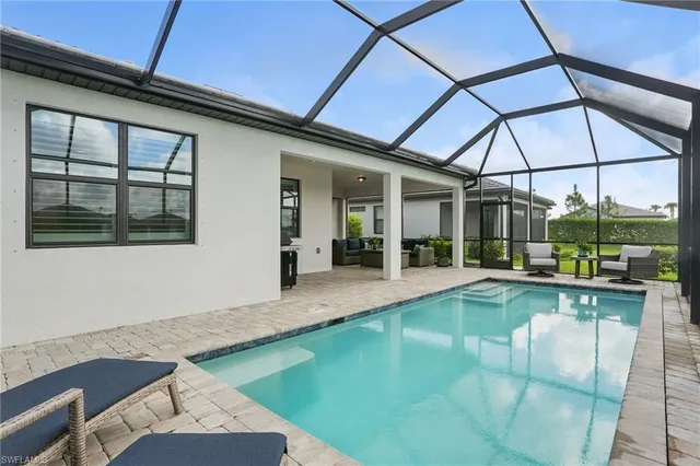a view of a backyard with a swimming pool