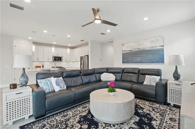 a living room with furniture and a chandelier
