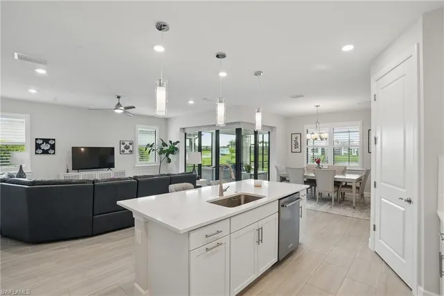 a large kitchen with kitchen island a sink a counter space and stainless steel appliances