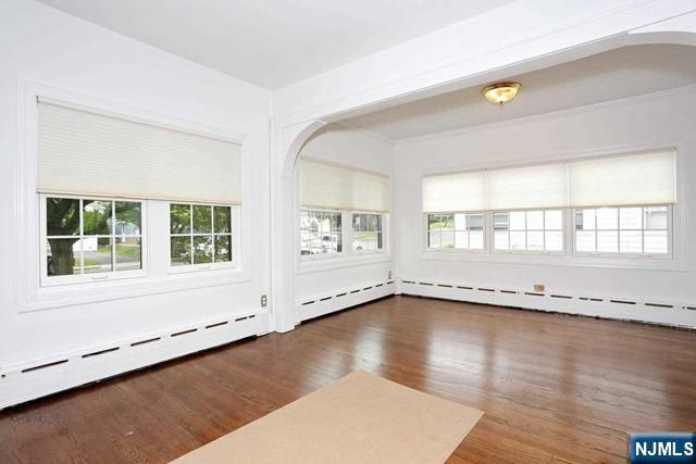 220 Raymond Street Hasbrouck Heights, NJ 07604 - Photo 12 of 36 an empty room with wooden floor and windows