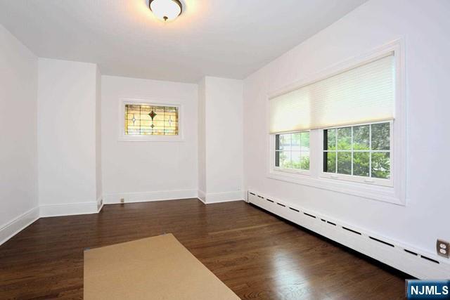 220 Raymond Street Hasbrouck Heights, NJ 07604 - Photo 14 of 36 a view of an empty room with wooden floor and a window