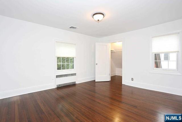 220 Raymond Street Hasbrouck Heights, NJ 07604 - Photo 18 of 36 an empty room with wooden floor and windows