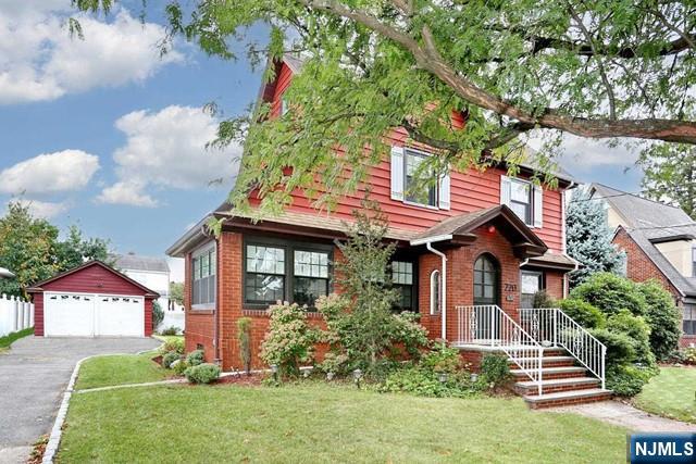 220 Raymond Street Hasbrouck Heights, NJ 07604 - Photo 2 of 36 a front view of a house with garden