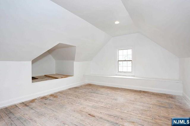 220 Raymond Street Hasbrouck Heights, NJ 07604 - Photo 25 of 36 an empty room with wooden floor and windows