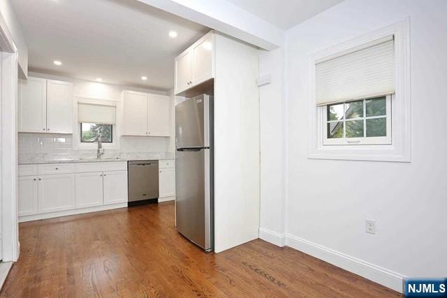 220 Raymond Street Hasbrouck Heights, NJ 07604 - Photo 4 of 36 a kitchen with a refrigerator a sink and cabinets