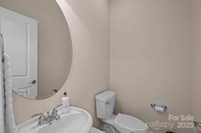 a white toilet sitting next to a bathroom sink