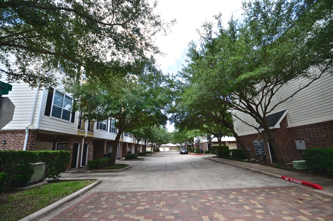 9200 Westheimer Road, Unit 907 Houston, TX 77063 - Photo 18 of 27 a city street lined with buildings and trees