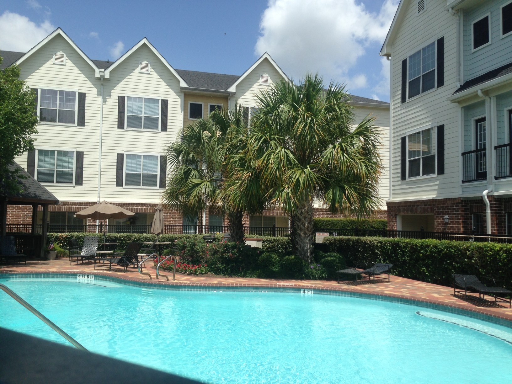 9200 Westheimer Road, Unit 907 Houston, TX 77063 - Photo 19 of 27 a front view of a house with a yard and potted plants