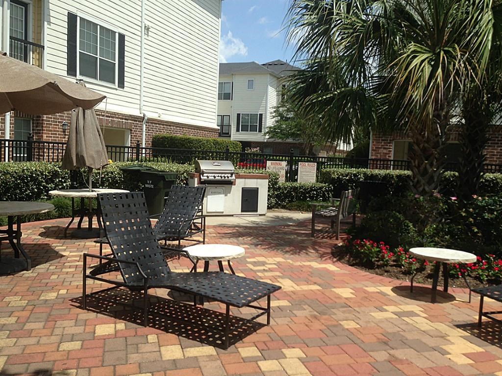 9200 Westheimer Road, Unit 907 Houston, TX 77063 - Photo 20 of 27 a view of a chairs and table in backyard of the house