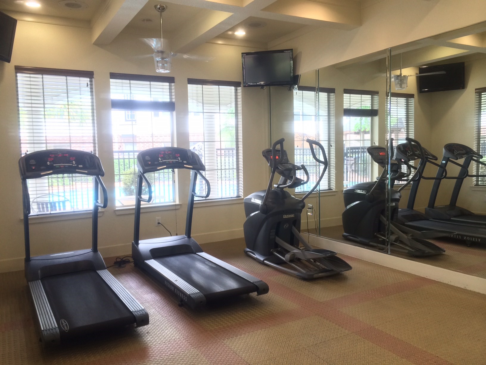 9200 Westheimer Road, Unit 907 Houston, TX 77063 - Photo 22 of 27 a room with gym equipment and a large window