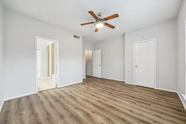 a bathroom with a granite countertop sink toilet a large mirror a vanity and shower