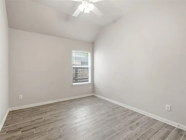 a view of a house with a small yard and wooden fence