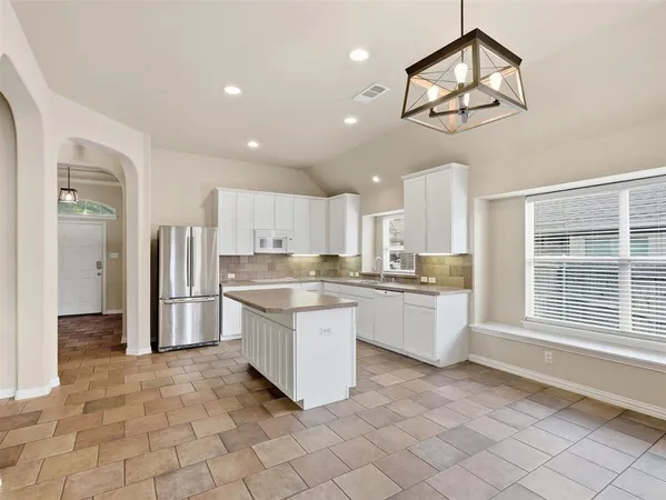 a view of a livingroom with wooden floor and a kitchen