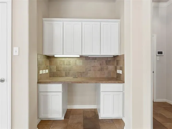 a view of empty room with wooden floor and fireplace