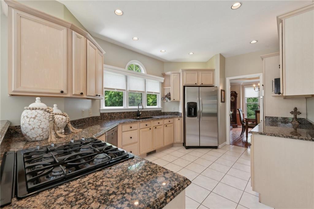 1107 Laurelview Drive Latrobe, PA 15650 - Photo 14 of 50 a kitchen with stainless steel appliances granite countertop a stove a sink and a refrigerator