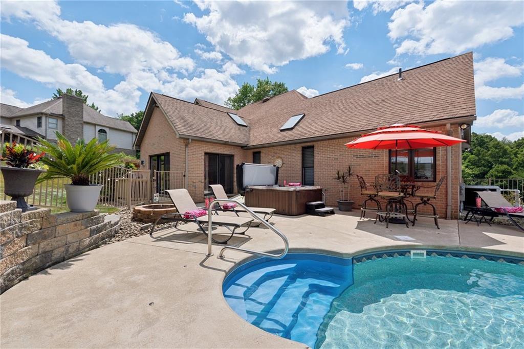 1107 Laurelview Drive Latrobe, PA 15650 - Photo 44 of 50 a view of a patio with a table and chairs under an umbrella