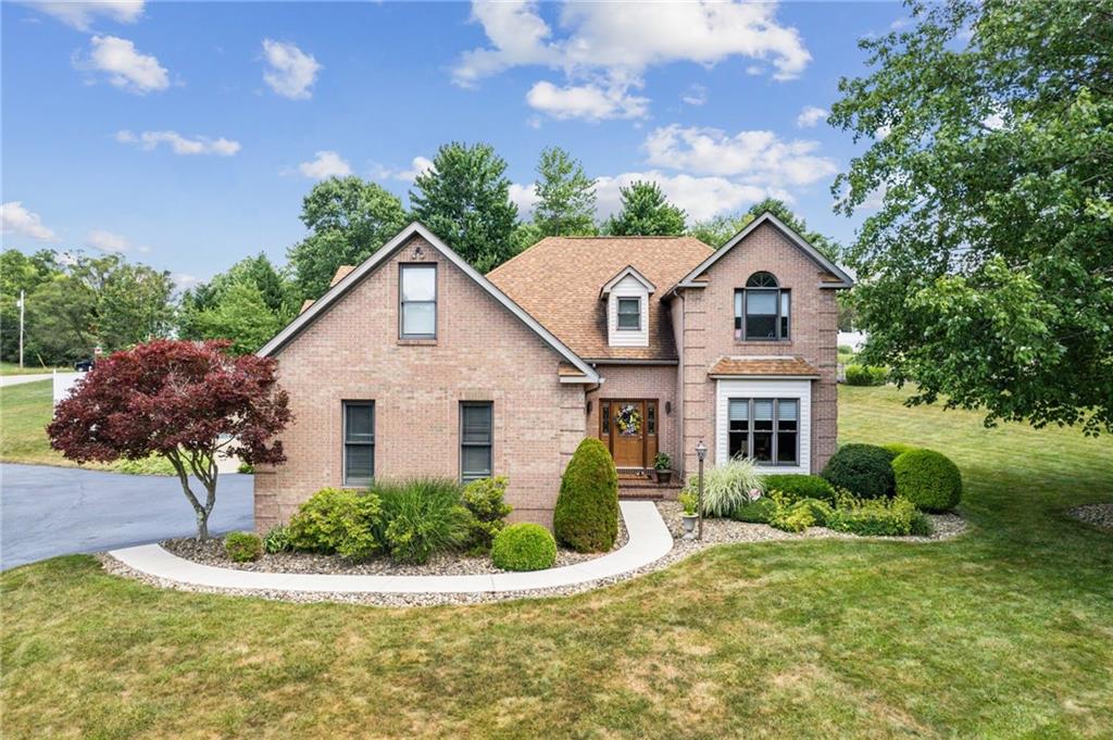1107 Laurelview Drive Latrobe, PA 15650 - Photo 46 of 50 a front view of a house with a yard and potted plants