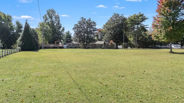 a view of a hallway view with wooden floor and staircase