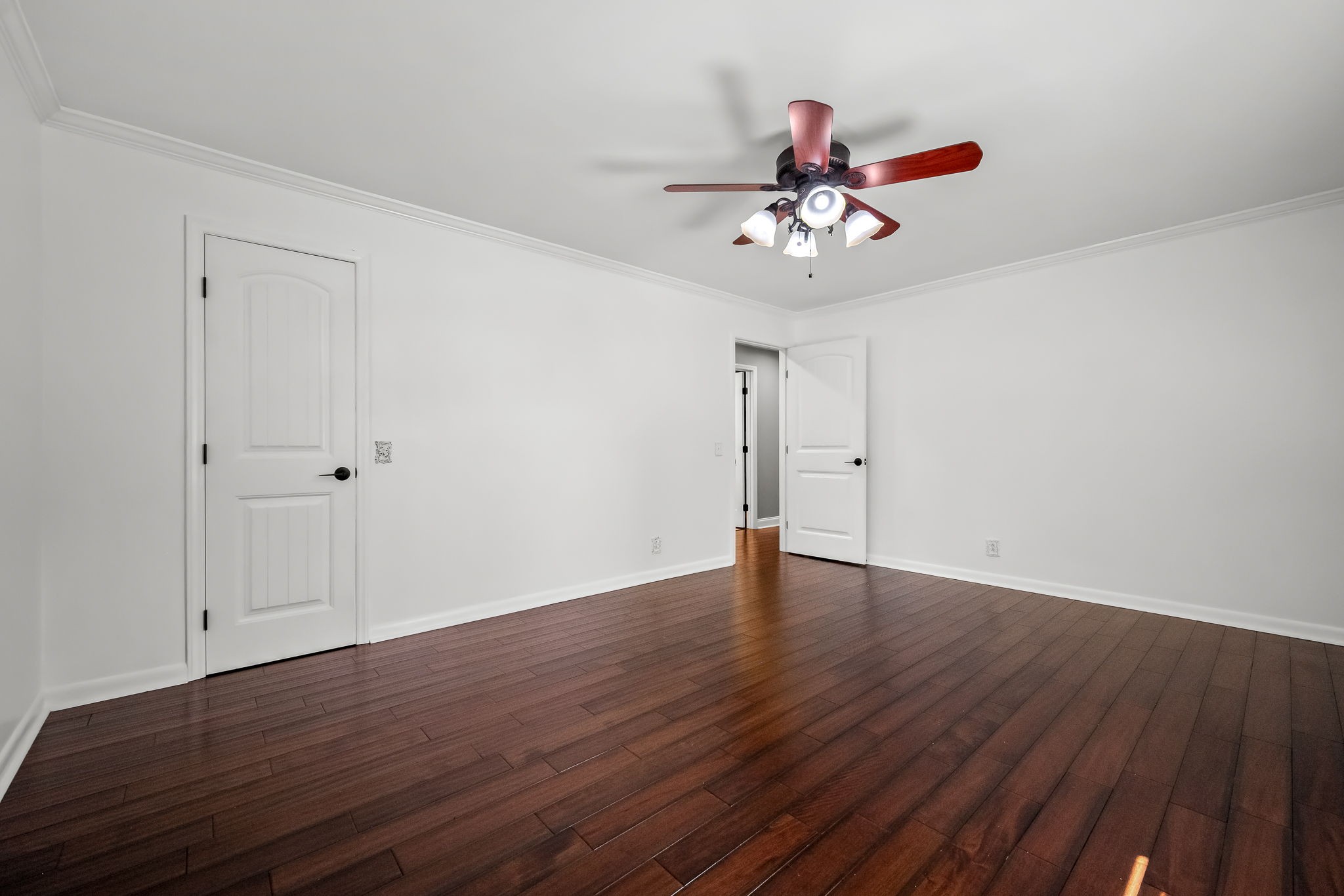 2329 Dilton Mankin Road Murfreesboro, TN 37127 - Photo 34 of 95 a view of an empty room with wooden floor and a ceiling fan