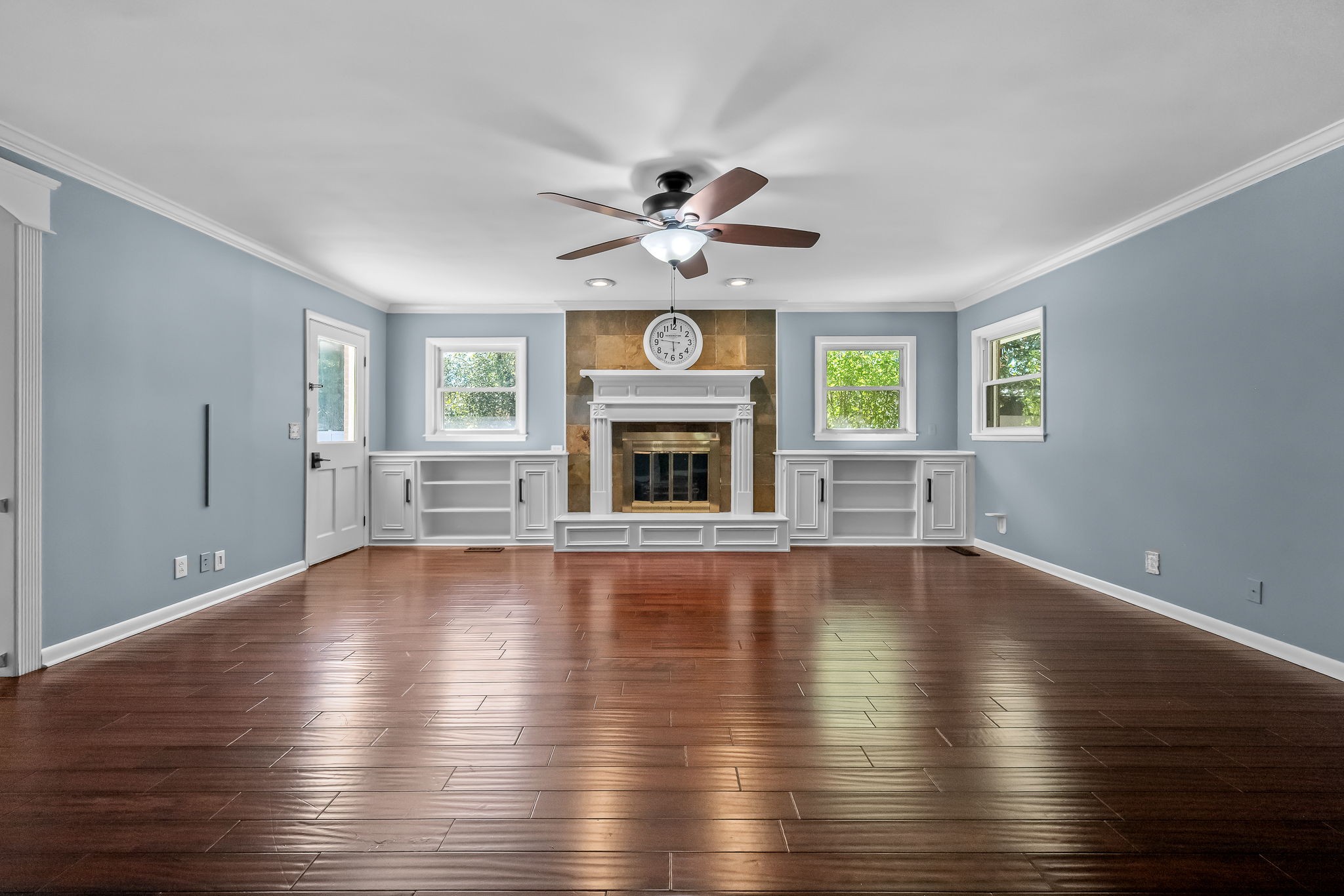 2329 Dilton Mankin Road Murfreesboro, TN 37127 - Photo 39 of 95 an empty room with wooden floor fireplace and windows