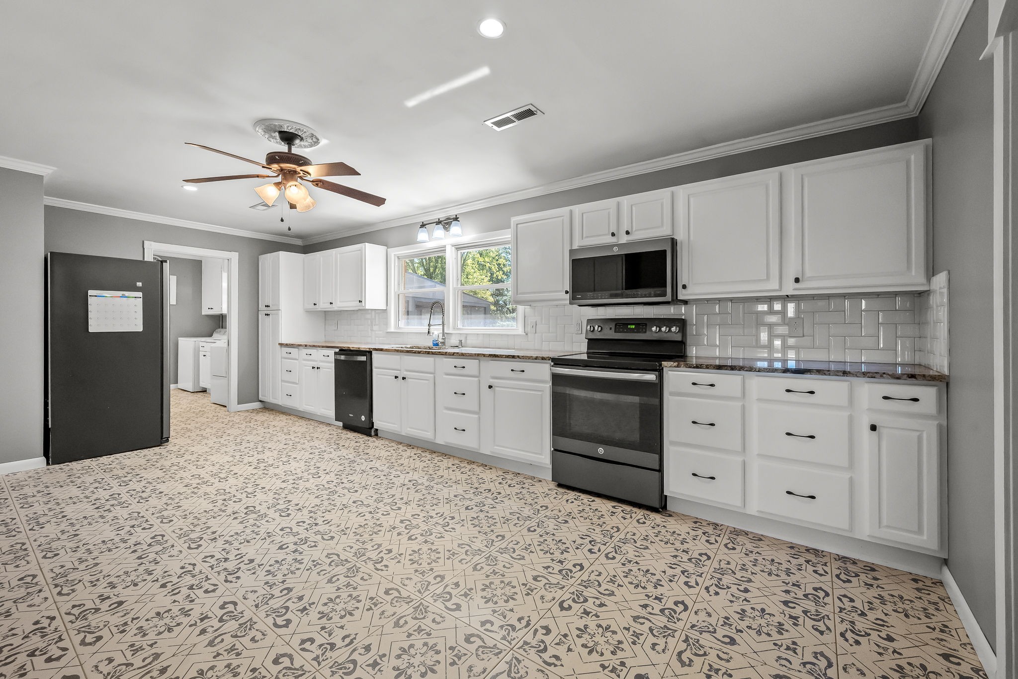 2329 Dilton Mankin Road Murfreesboro, TN 37127 - Photo 46 of 95 a kitchen with a stove a sink and a refrigerator