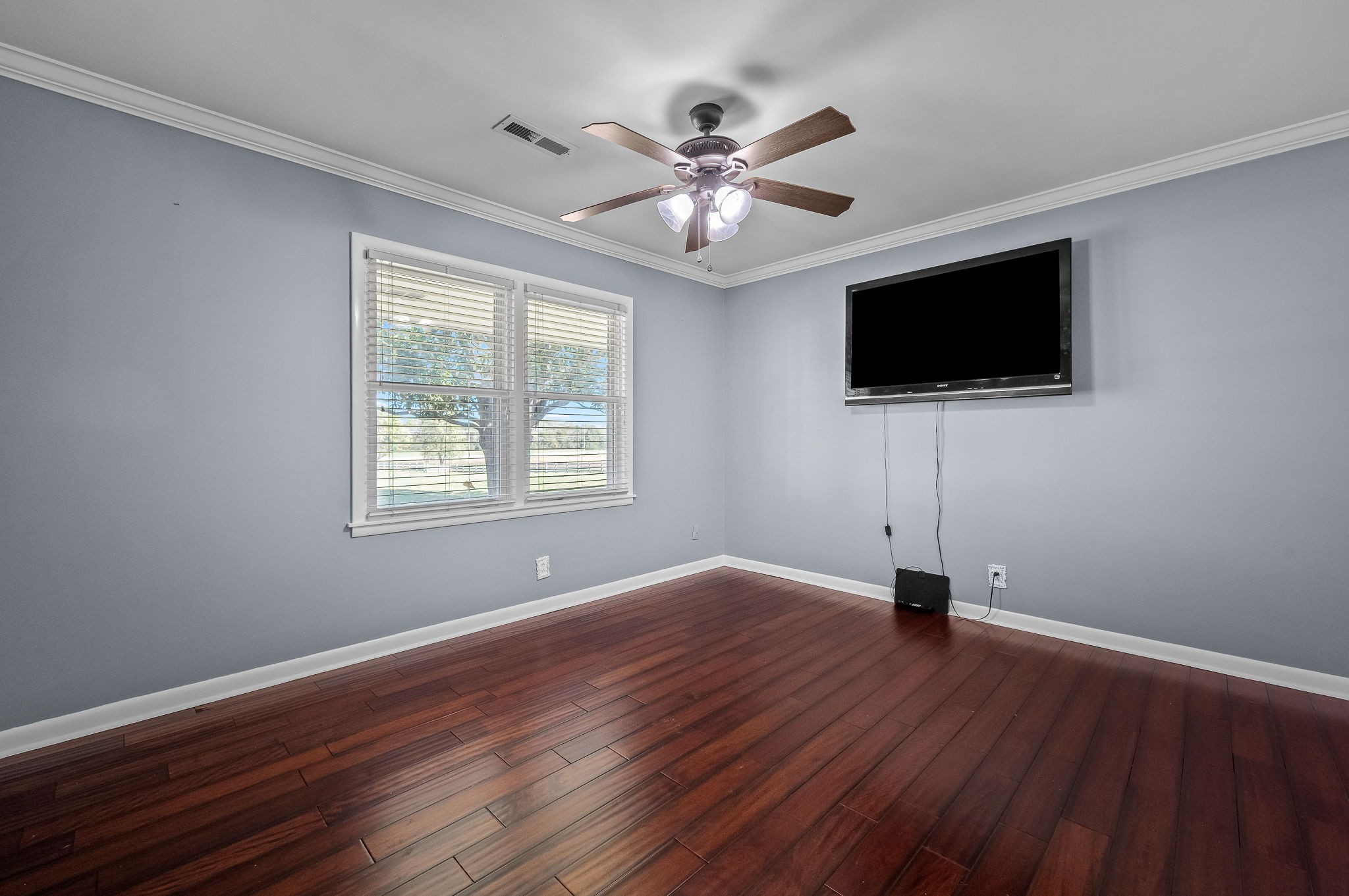 2329 Dilton Mankin Road Murfreesboro, TN 37127 - Photo 49 of 95 a view of a livingroom with a flat screen tv wooden floor and a ceiling fan