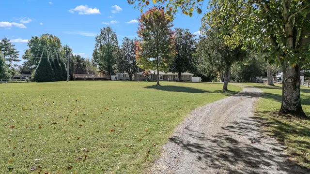 an aerial view of a house with outdoor space pool seating area and yard