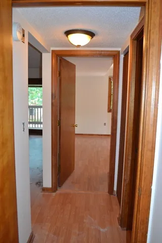 a view of a hallway with wooden shelves