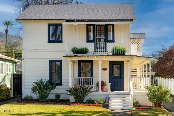 a front view of a house with yard and glass windows