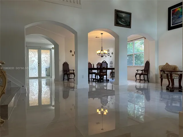 a kitchen with stainless steel appliances a sink cabinets and a window