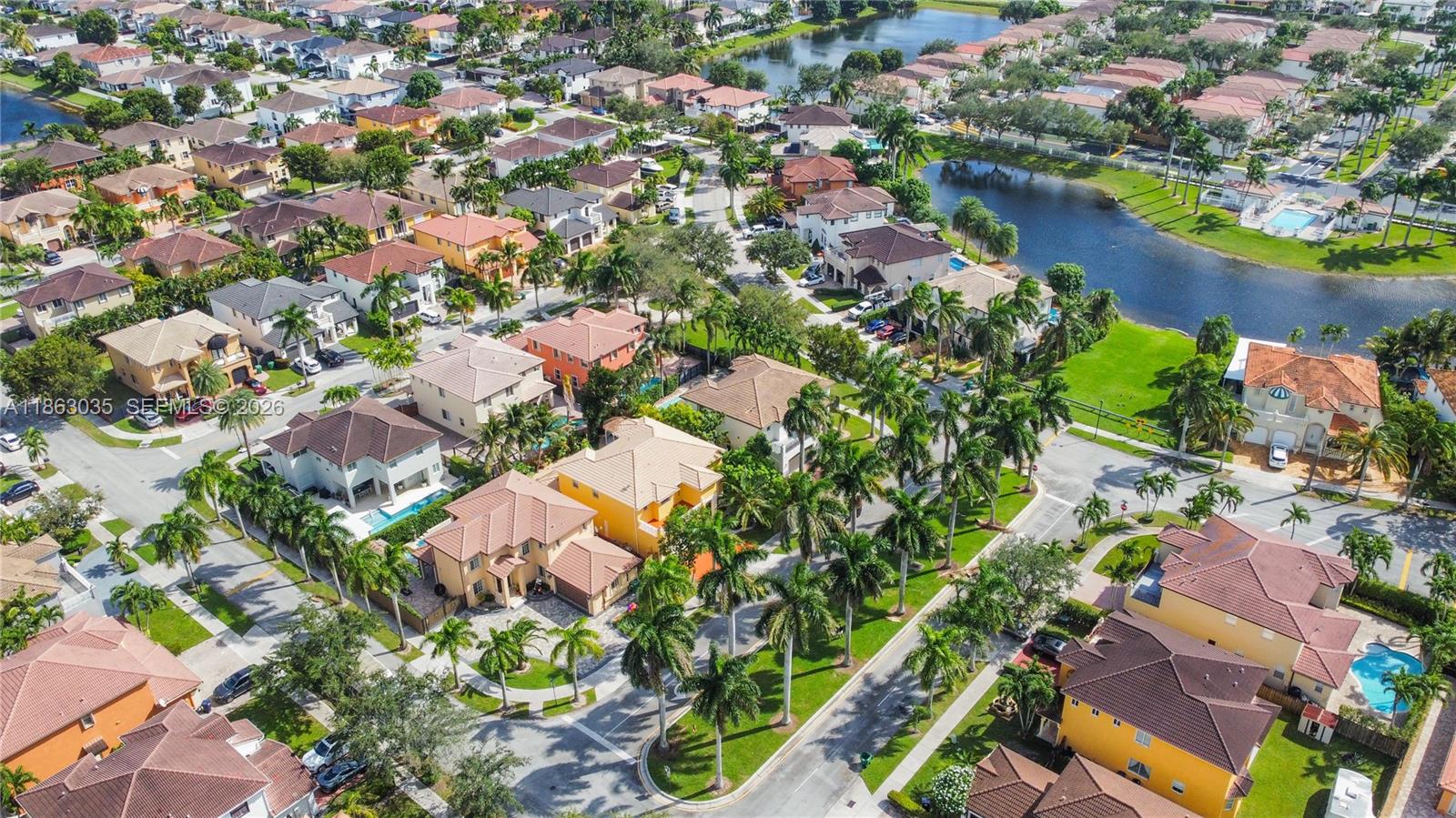 6049 Southwest 165th Avenue Miami, FL 33193 - Photo 16 of 49 an aerial view of residential houses with outdoor space and lake view