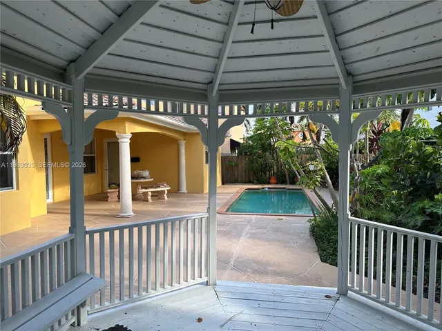a front view of a house with a garden and plants