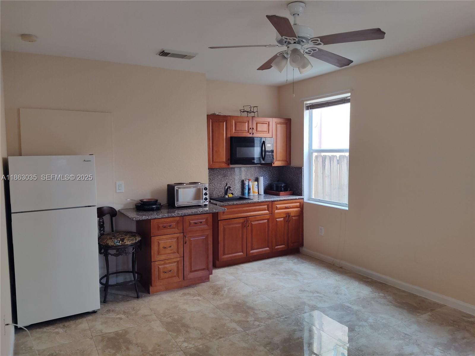 6049 Southwest 165th Avenue Miami, FL 33193 - Photo 30 of 47 a room with furniture a washer and a window