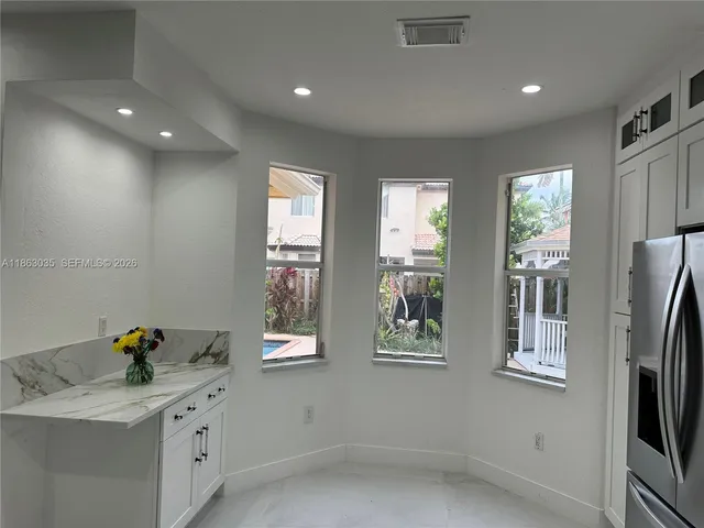 a view of a hallway with seating area