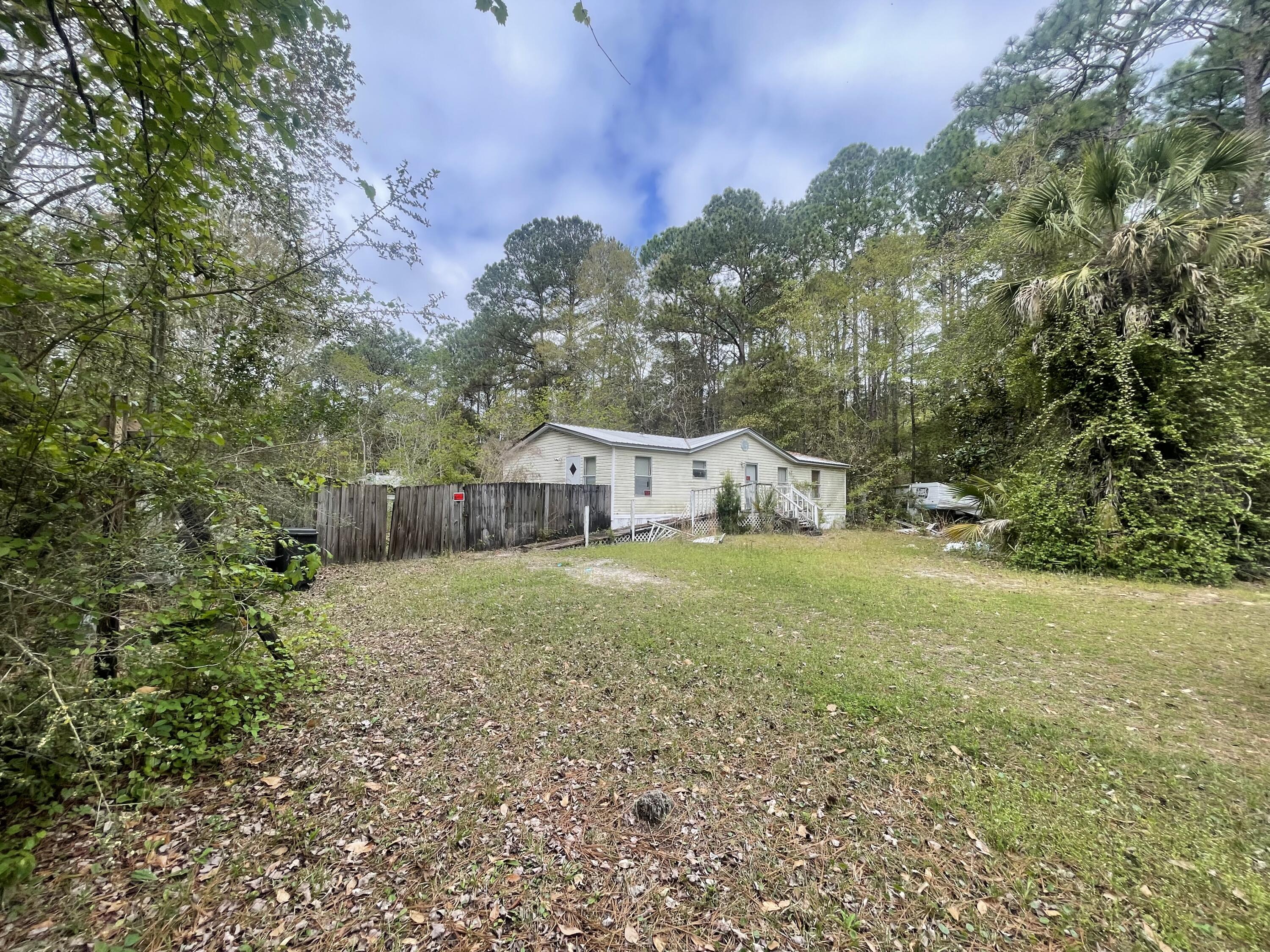93 Laird Drive Freeport, FL 32439 - Photo 3 of 12 a view of a house with backyard and trees