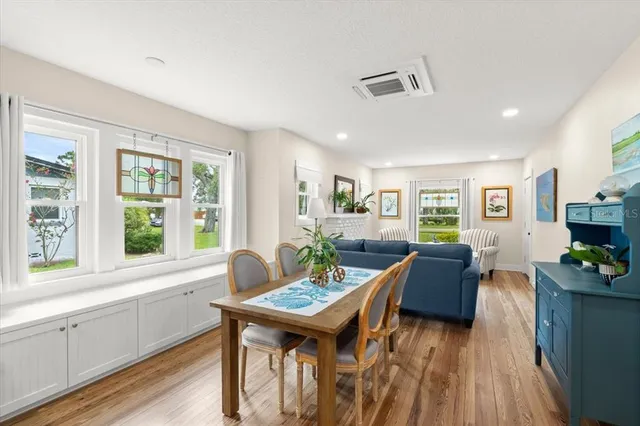a view of a dining room with furniture window and wooden floor