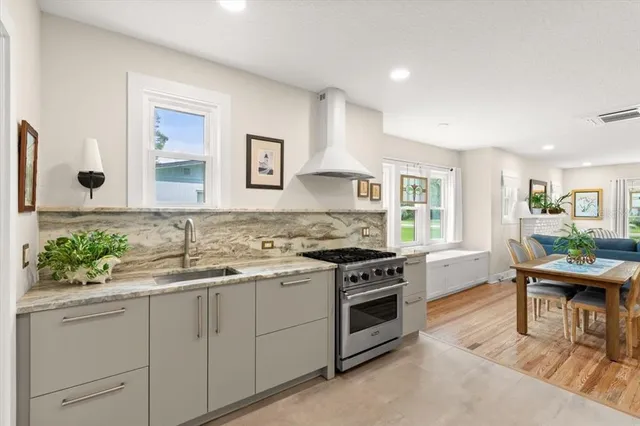 a kitchen with granite countertop a stove and cabinets