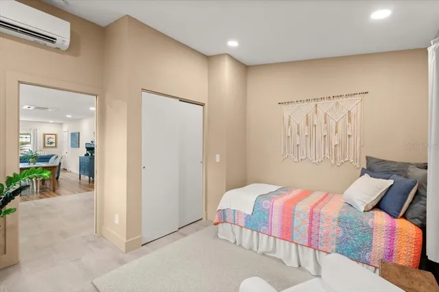 a living room with a couch and a potted plant