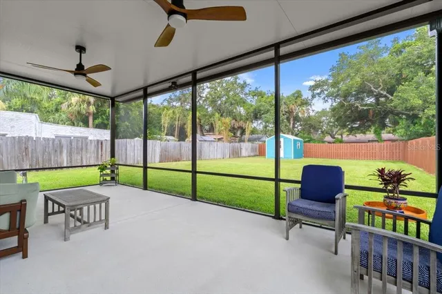a view of a deck with furniture and front door