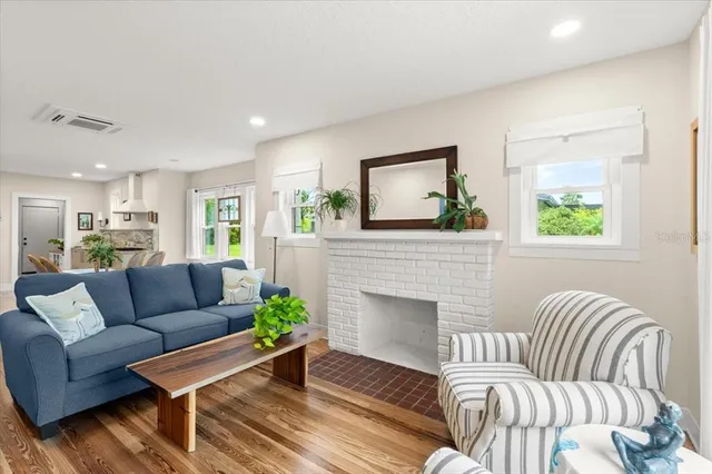 a living room with furniture and a fireplace