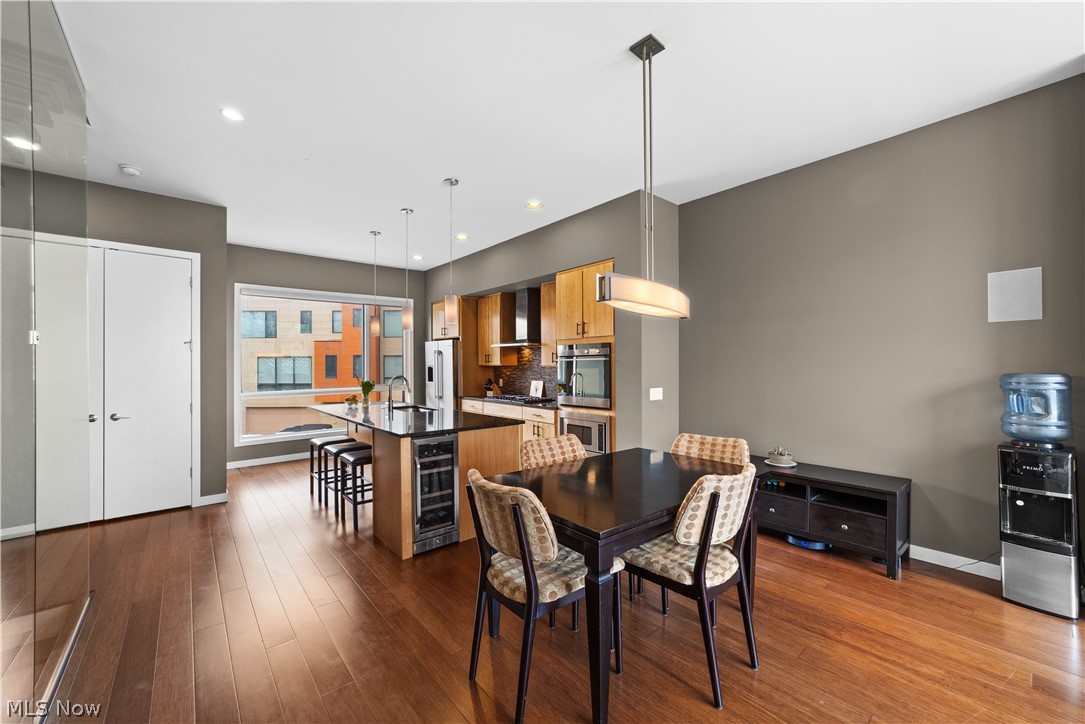 1868 Coltman Road Cleveland, OH 44106 - Photo 19 of 40 Dining area with beverage cooler, dark hardwood / wood-style floors, and sink
